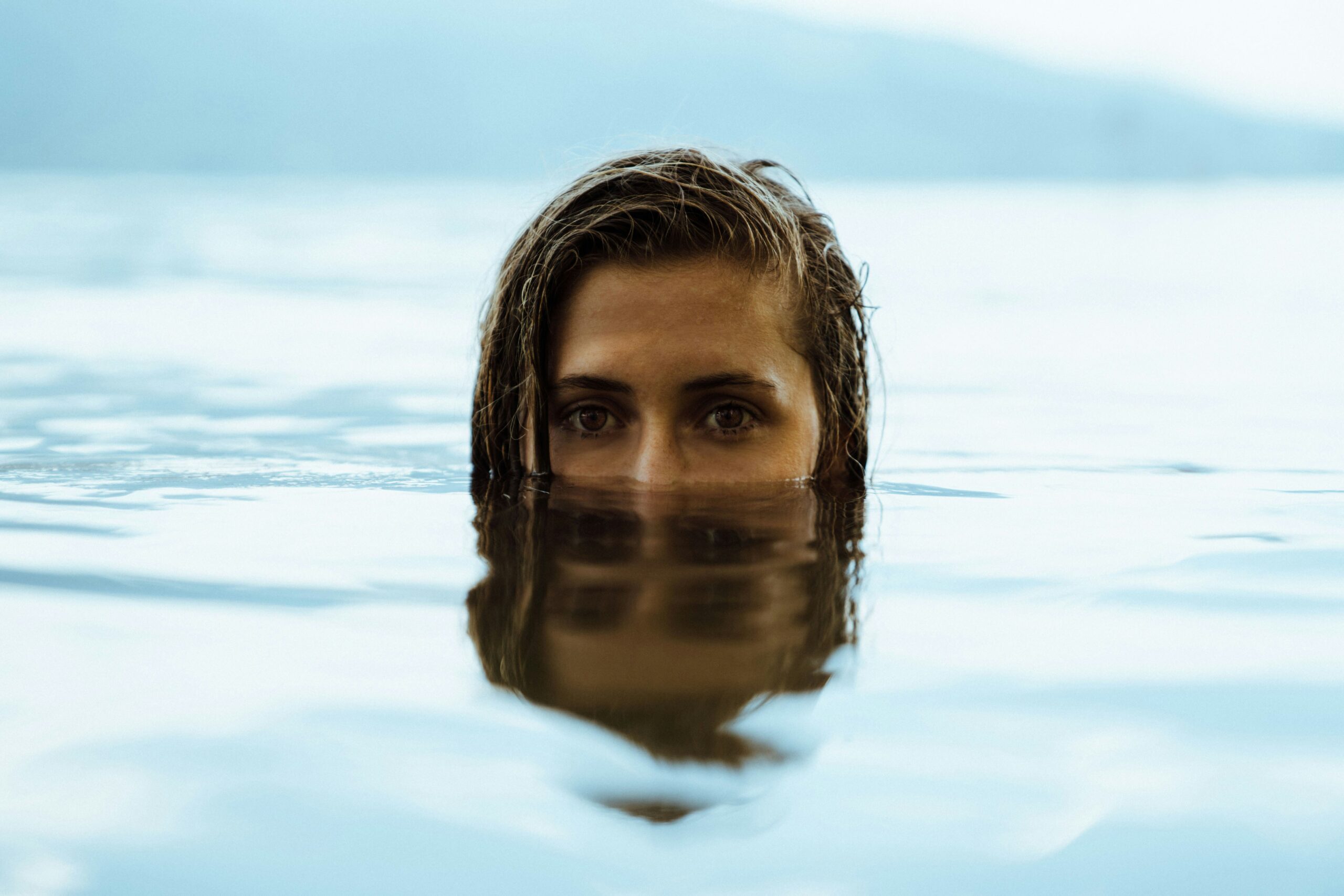 Woman's face poking up through sea water