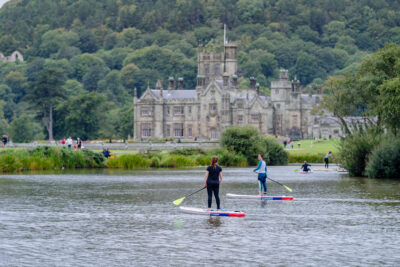 People paddleboard in Margam Country park.