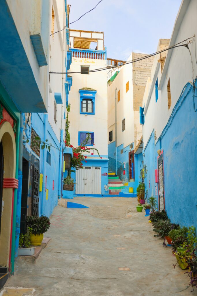 A street with white and blue walled houses in Taghazout, Morocco 