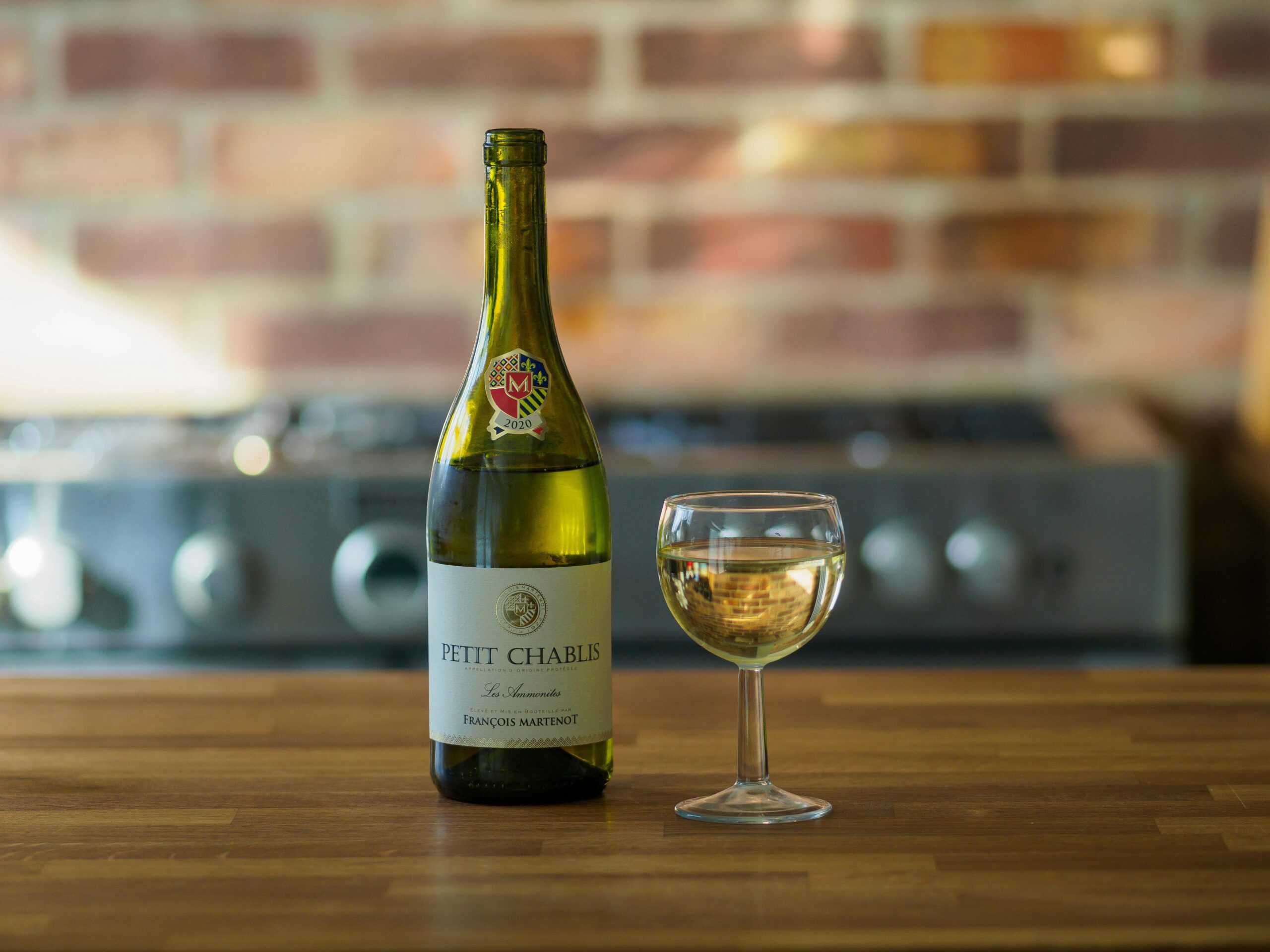 A bottle of Chablis white wine on a wooden kitchen surface