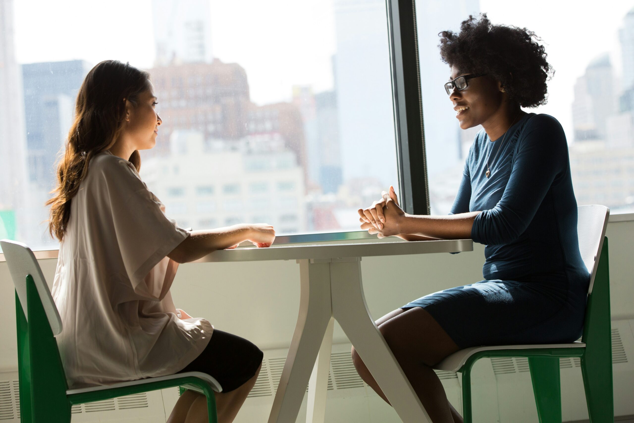 Woman sit down for a meeting.