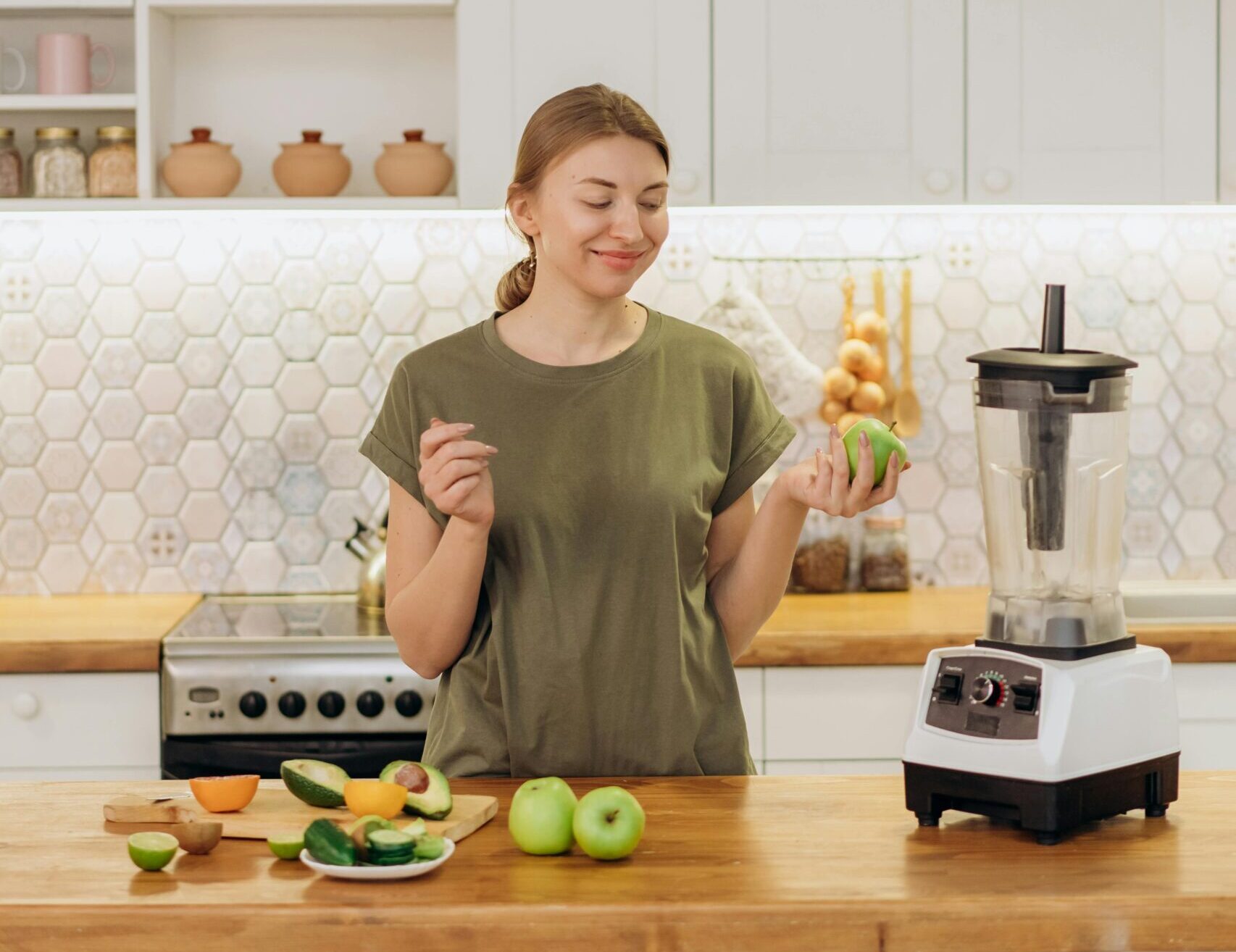 Woman prepares fruit for her juicer