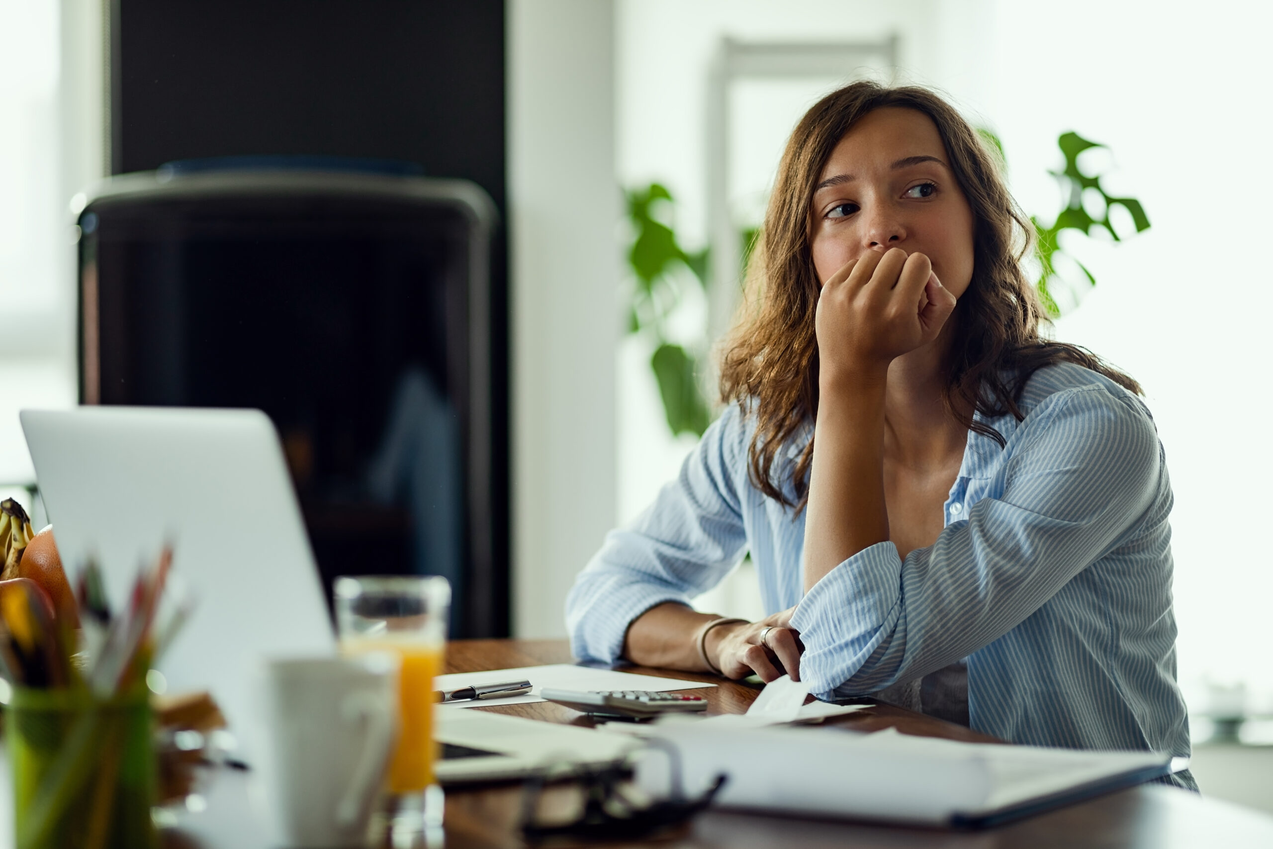 Woman stresses while on her laptop.