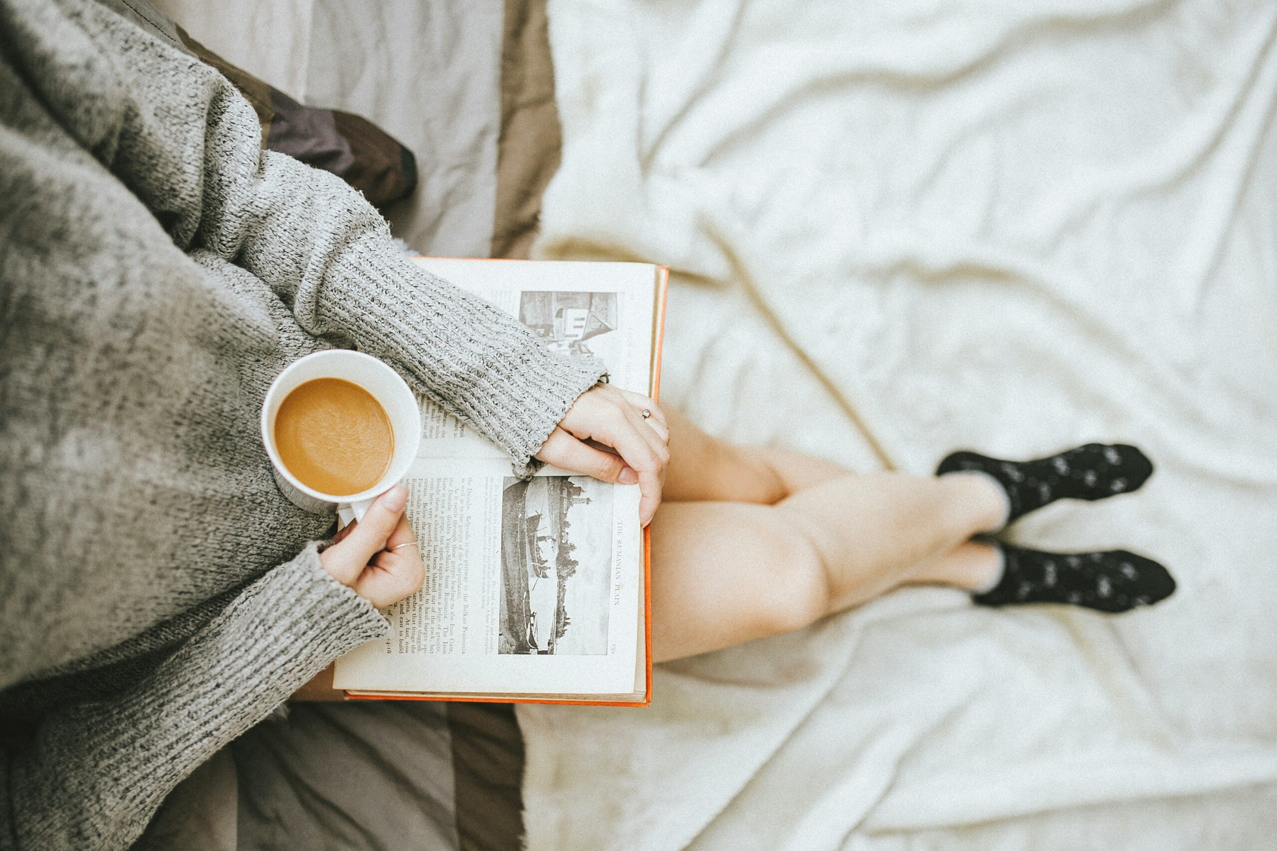 Woman sips a hot coffee while reading