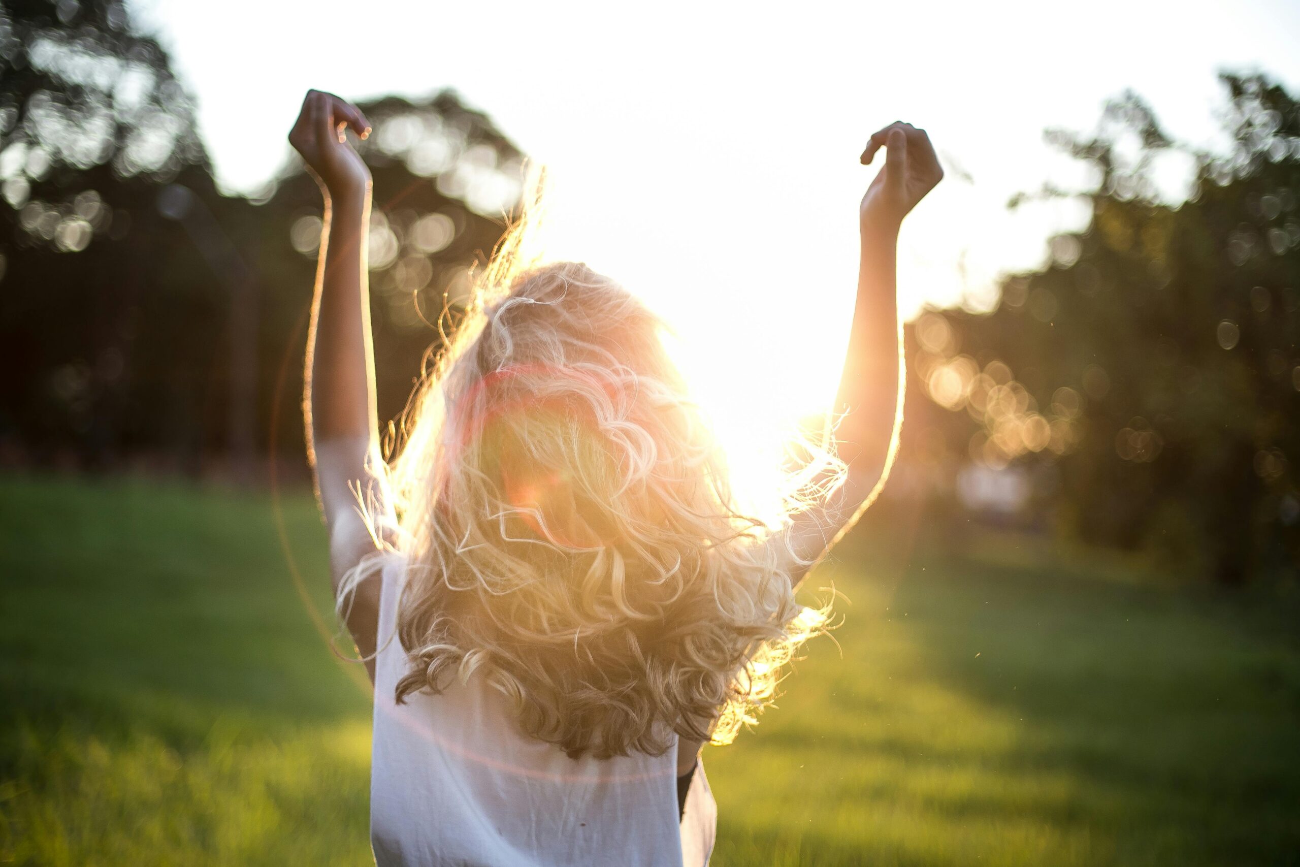 Happy woman with arms in the air