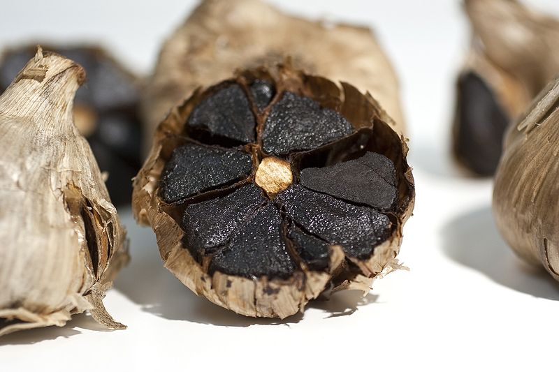 close up of cut open black garlic