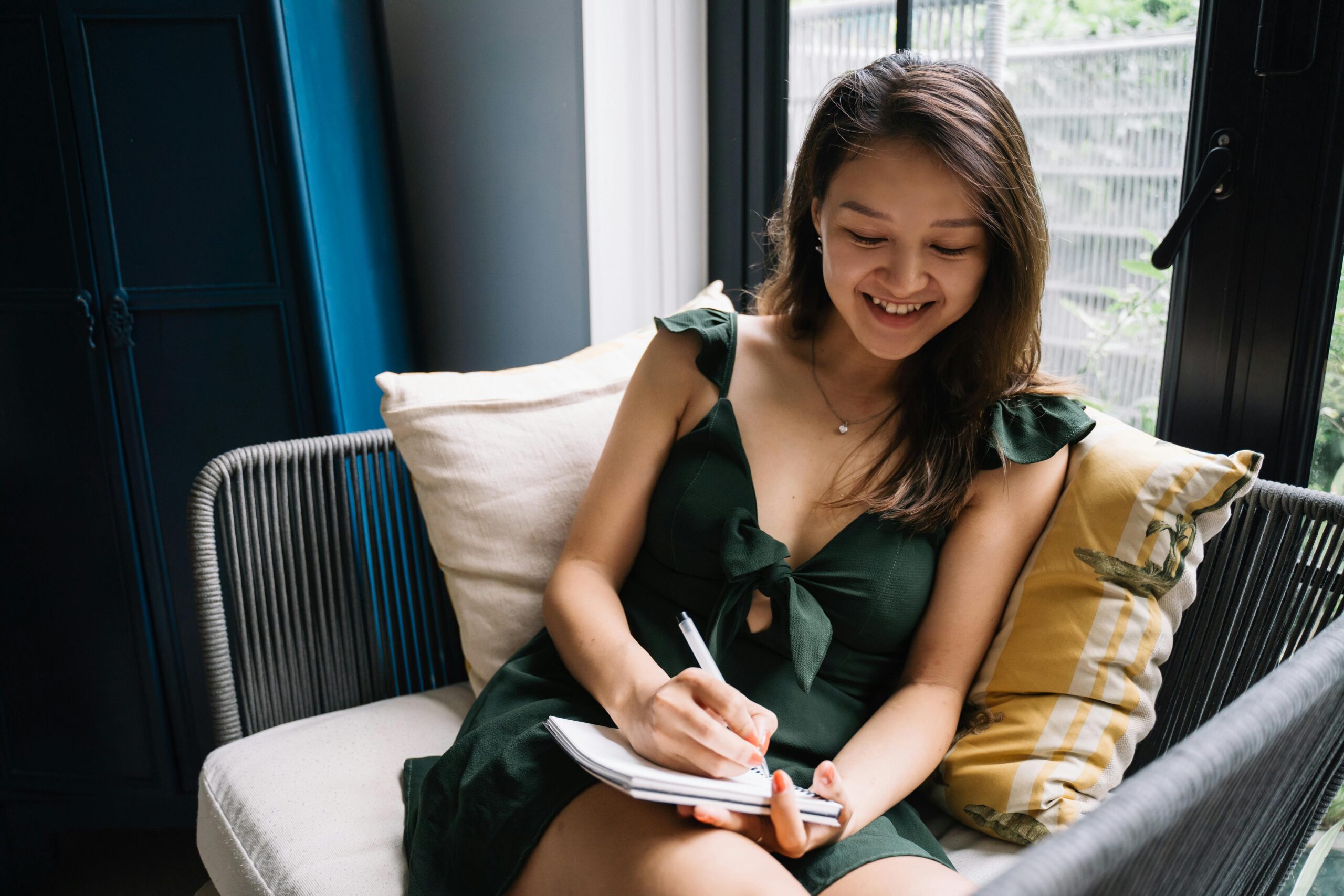 Woman smiles as she journals