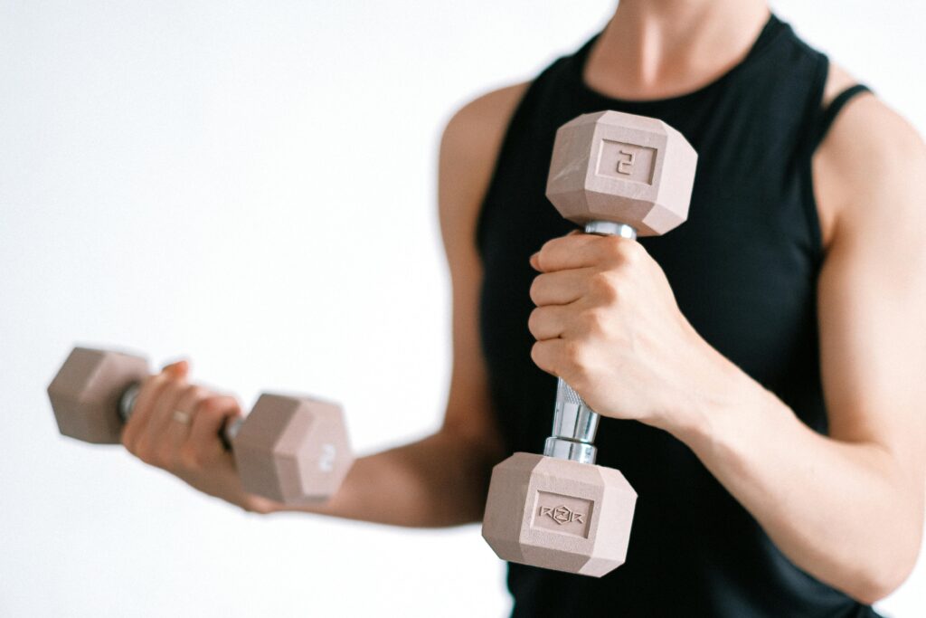 close up of a woman's hands holding 2kg dumbbells 