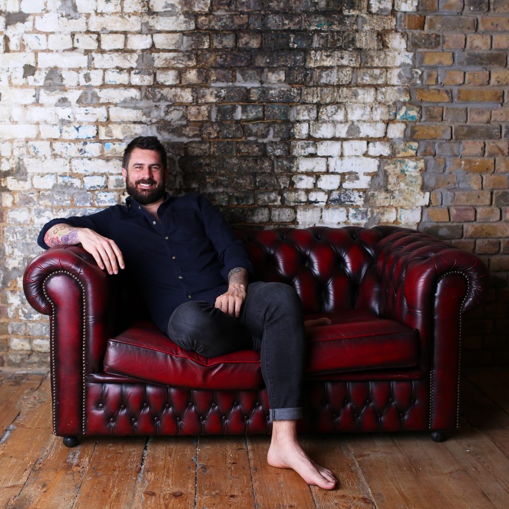 Michael Perry, aka Mr Plant Geek, relaxes on a sofa