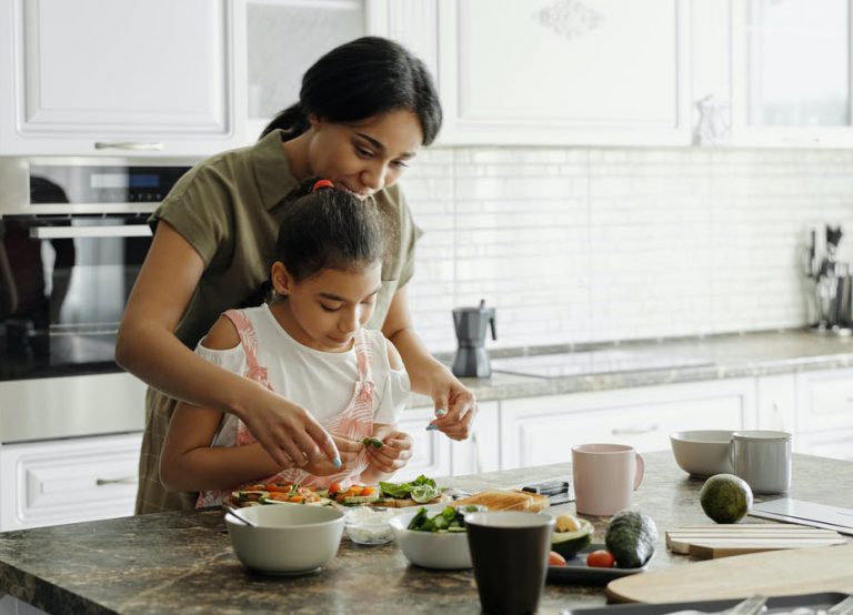 Mother and daughter cooking. © August de Richelieu