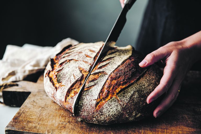 Slicing sourdough bread for supper.