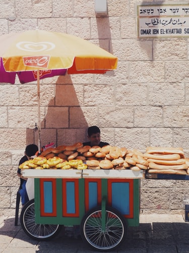 Pretzel sellers in Jerusalem sitting in the shade.