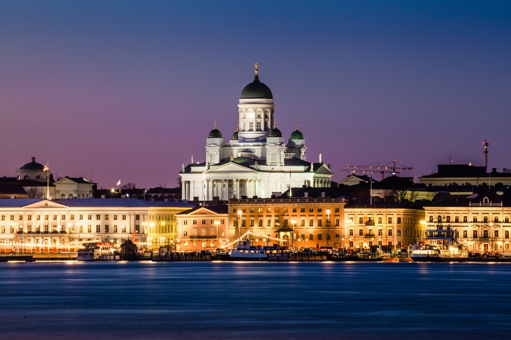 The Helsinki Cathedral lights up the skyline by night.