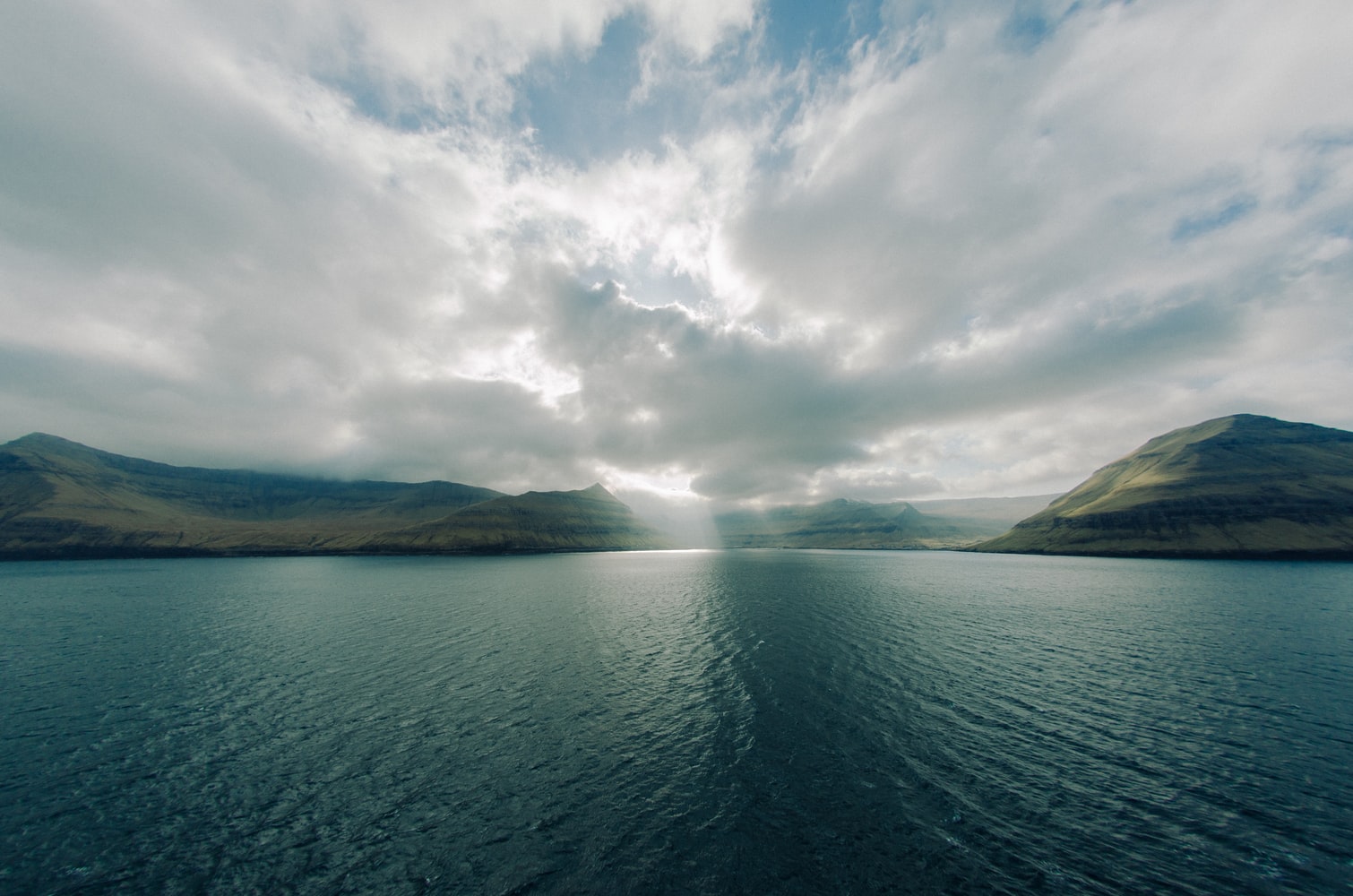 Sea view of Faroe Islands as the sun breaks through the clouds.