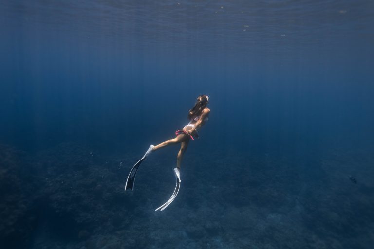 A diver swims in the depths of the sea in Ecuador.