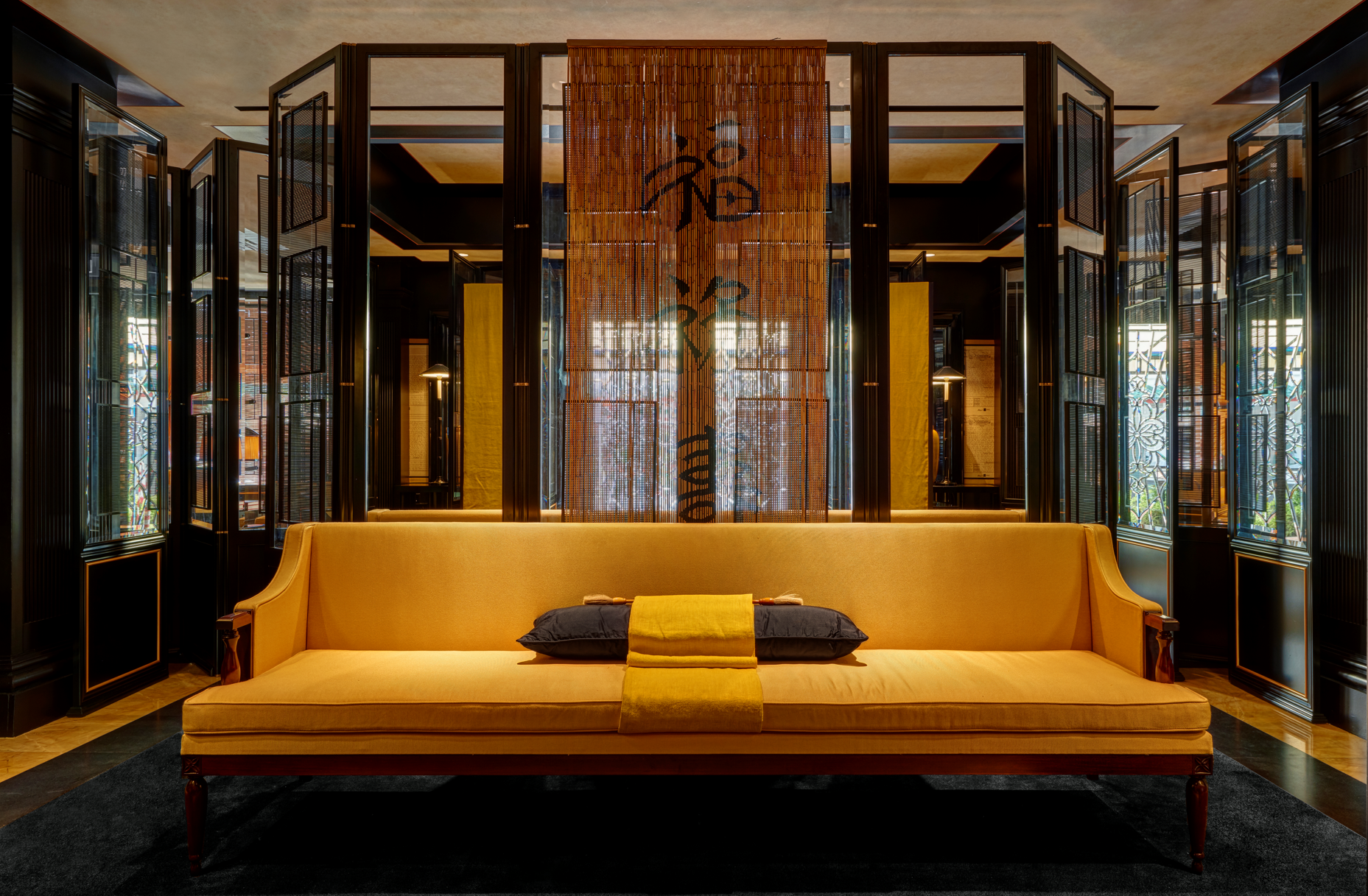 A stylish black and brown living room with a khaki sofa