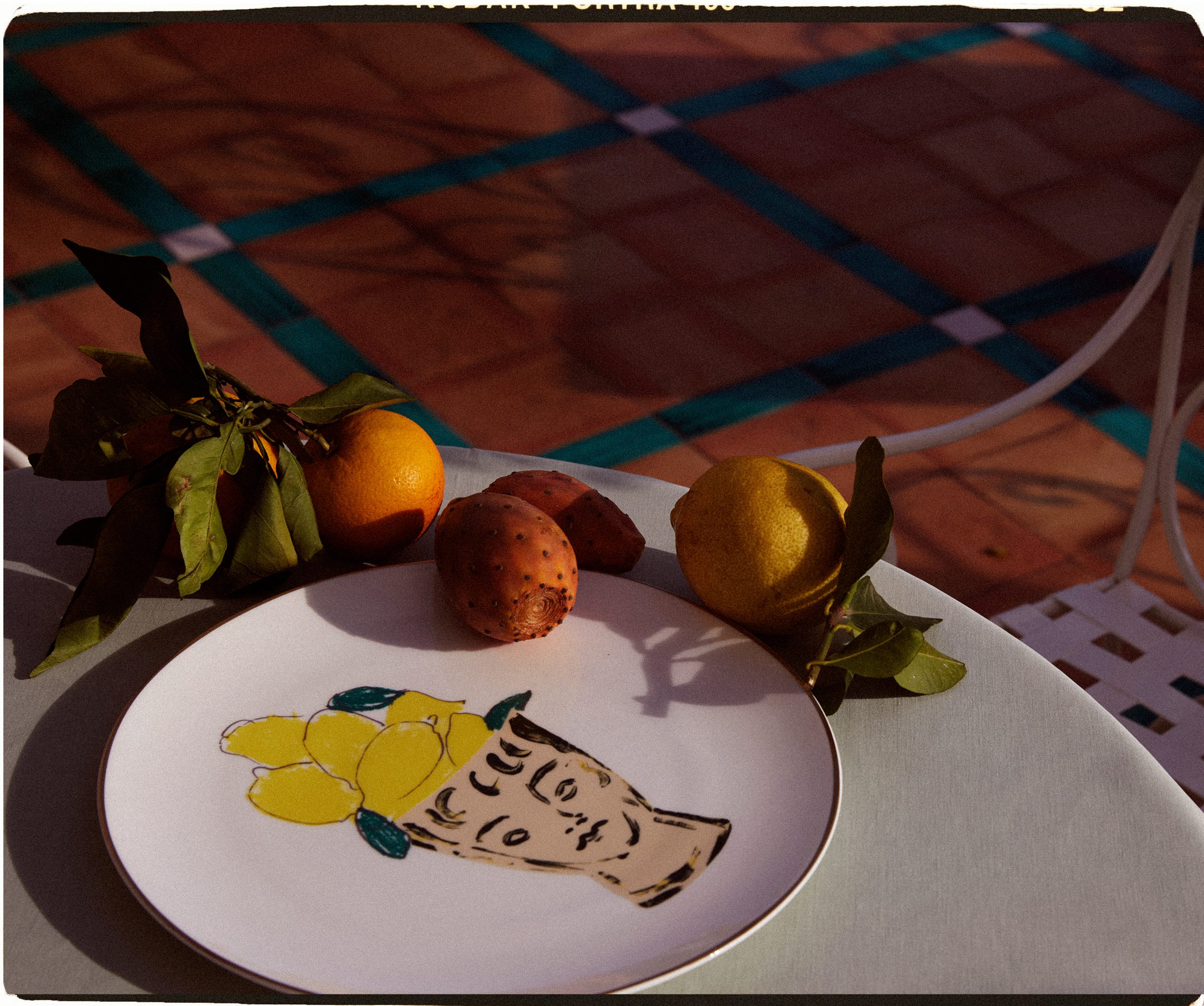 A Le Sirenuse plate next to a selection of fruit