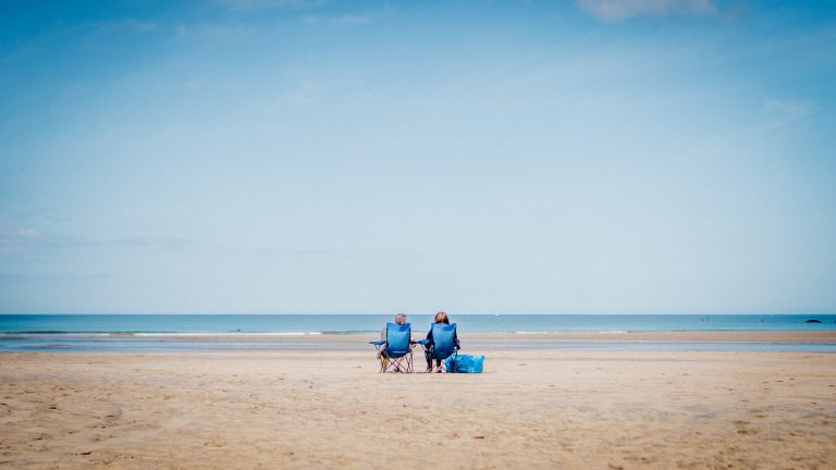The great expanse of West Sands beach, St Andrews, Fife, as a couple take in the sea air in the distance