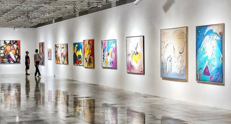 A showcase of the best of modern art paintings in a gallery.