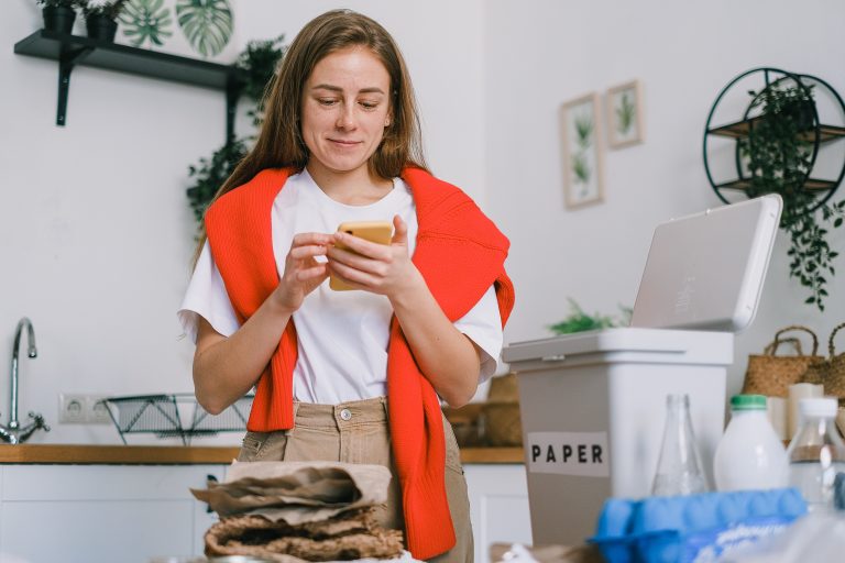 A woman uses a smart phone to run her eco friendly home.