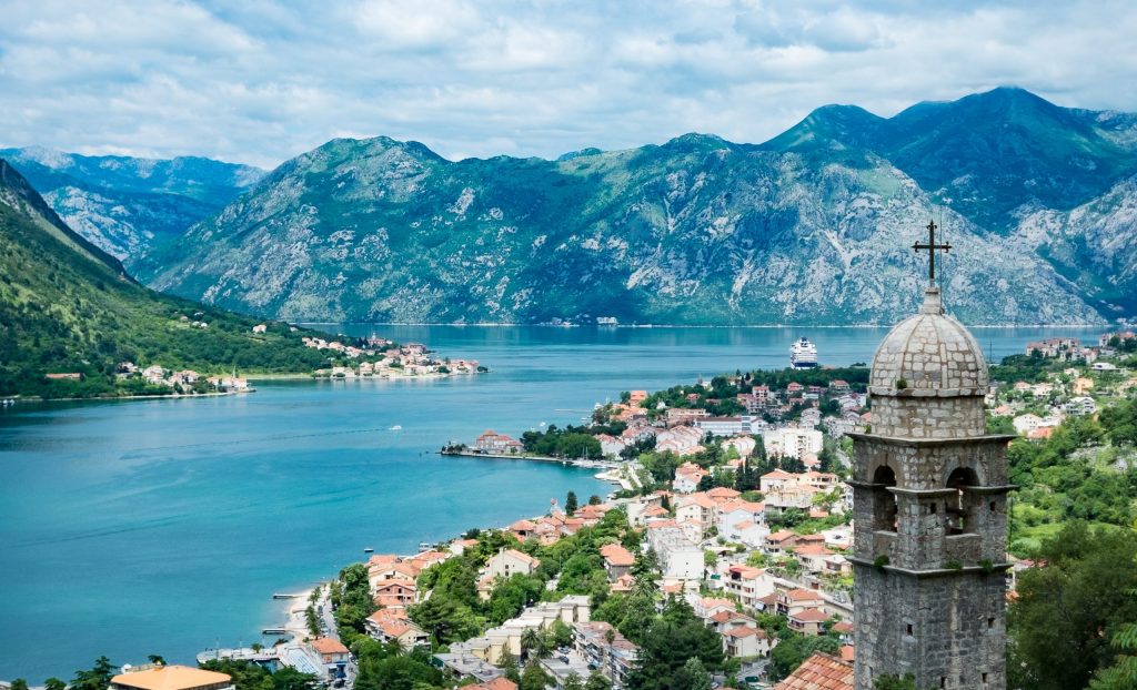 A scenic view of Montenegro with the sea winding past the mountains into the distance.