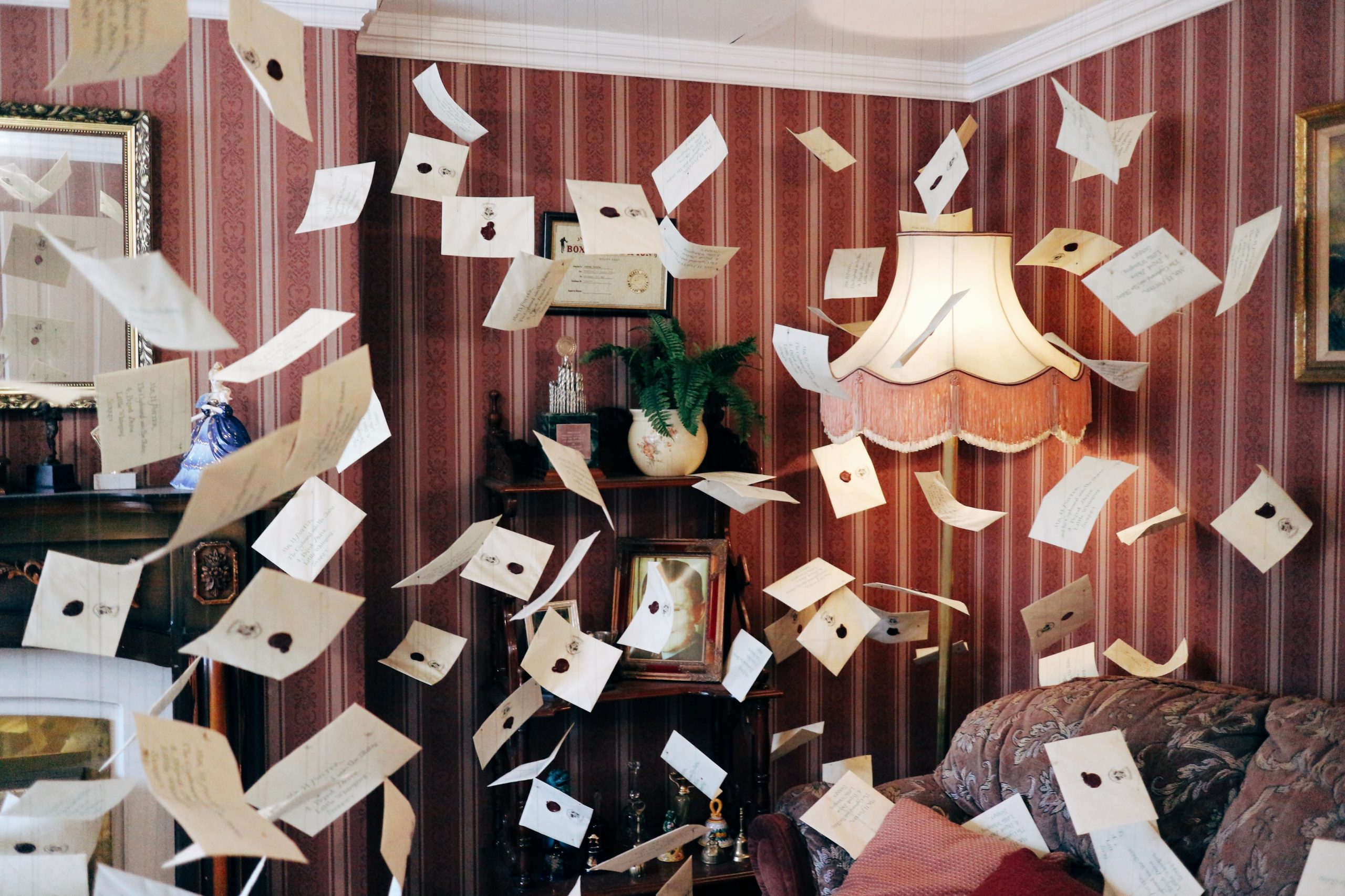 Letters fly through the fireplace of a living room in a scene recreated from Harry Potter courtesy of Warner Bros. Studio Tour.