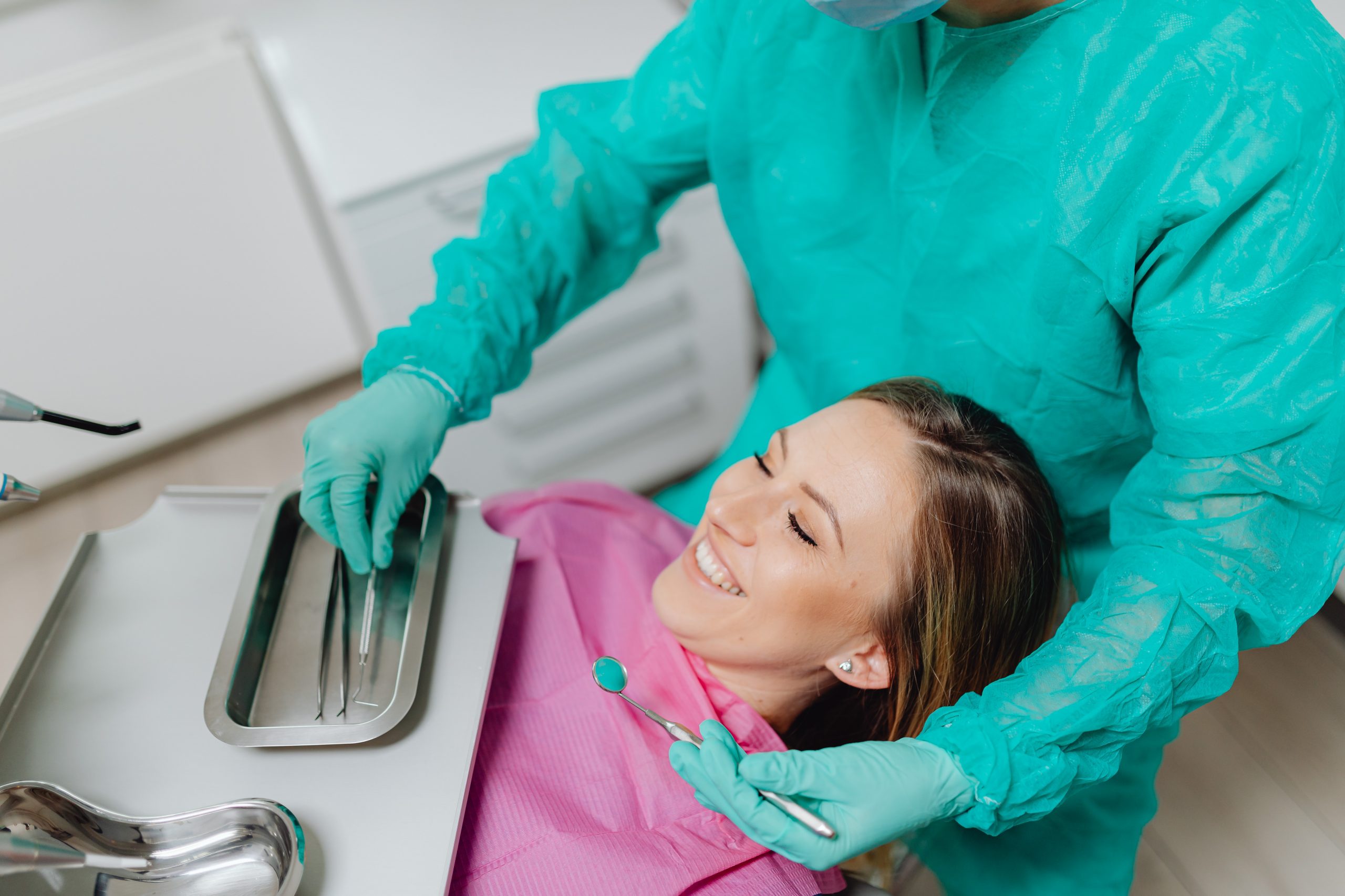 A dentist prepares a patient for cosmetic dentistry, making her feel relaxed.