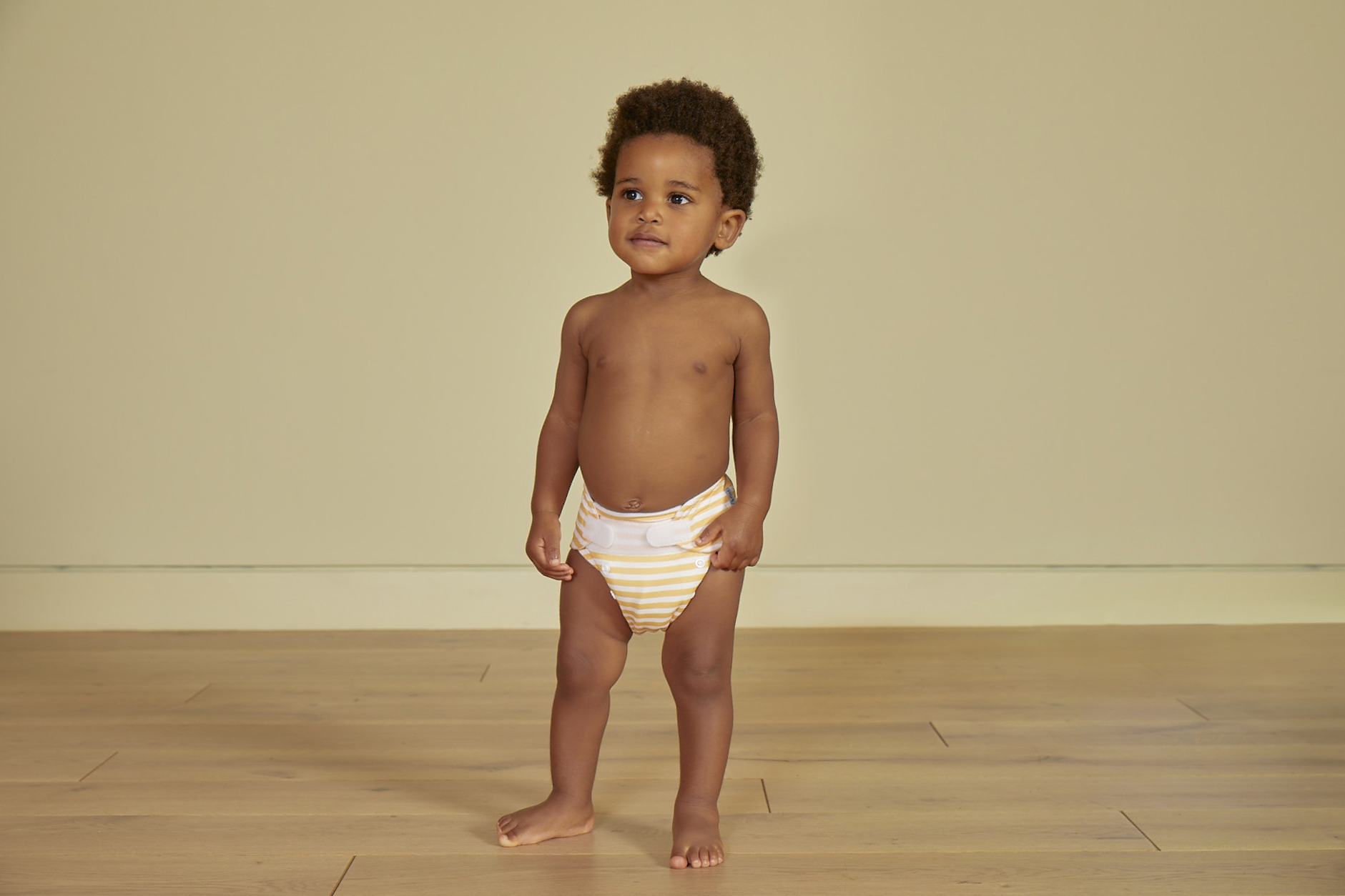 A young black baby models Kit and Kin's reusable nappies.