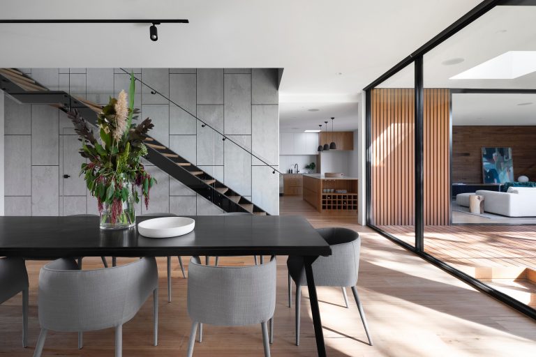 A spacious open plan room with modern furniture.