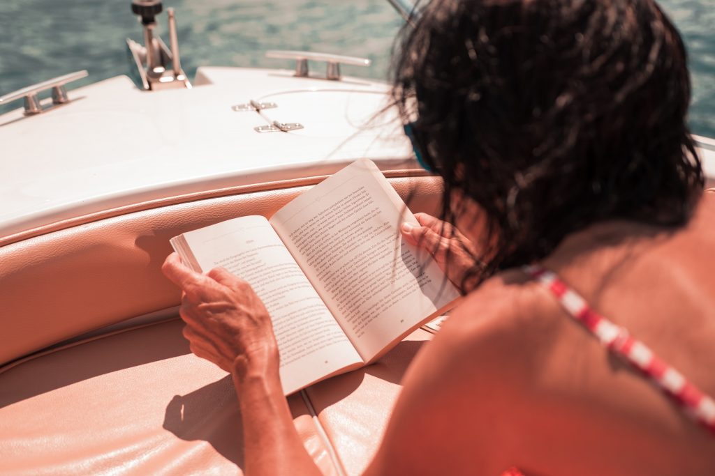 A woman reading a novel on holiday.