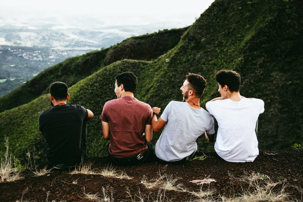 Out hiking in the hills, four friends share a moment together.