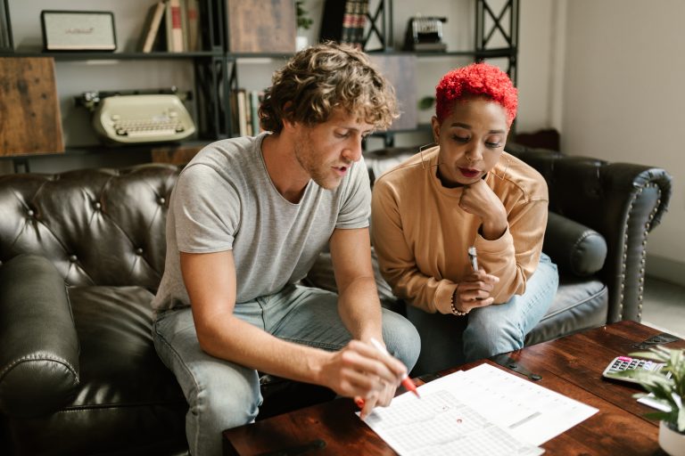 A mixed-race couple discussing the terms of their divorce with each other.