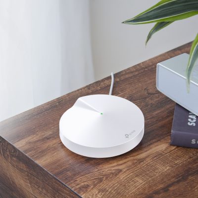 The TP-Link Deco M5 on a table top.