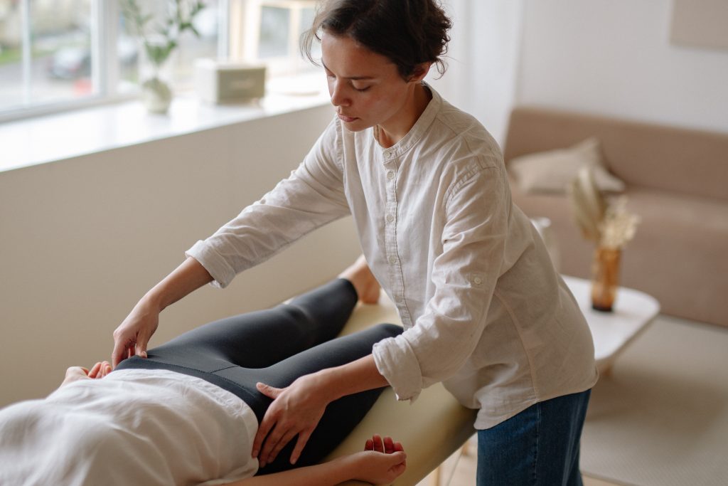 A physiotherapist examining her patient for pelvic pain.