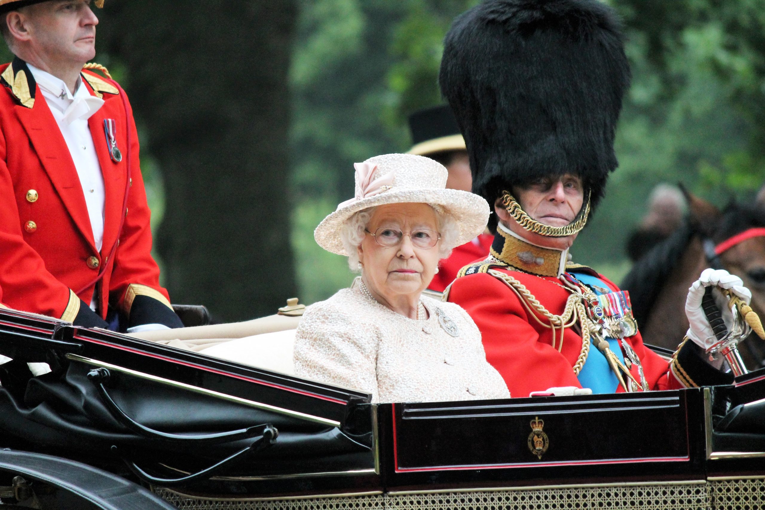 The Queen's guards escorting Queen Elizabeth II back to Buckingham Palace in her carriage.