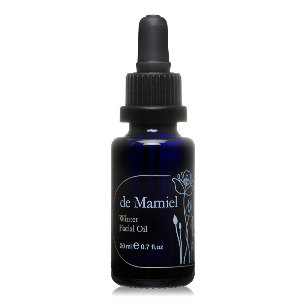 A 20ml black bottle of de Mamiel Winter Facial Oil against a white background.