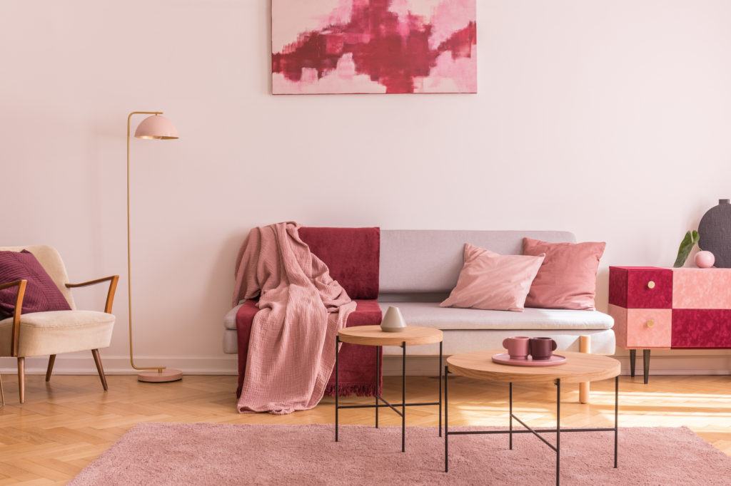 Inviting living room featuring a sofa adorned with a Viva magenta throw.