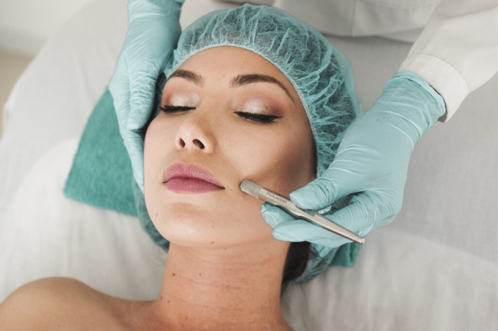Woman wearing surgical cap undergoing a beauty therapy