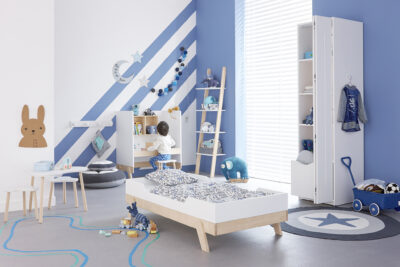 Child's bedroom with bed, toys and desk, in white and blue