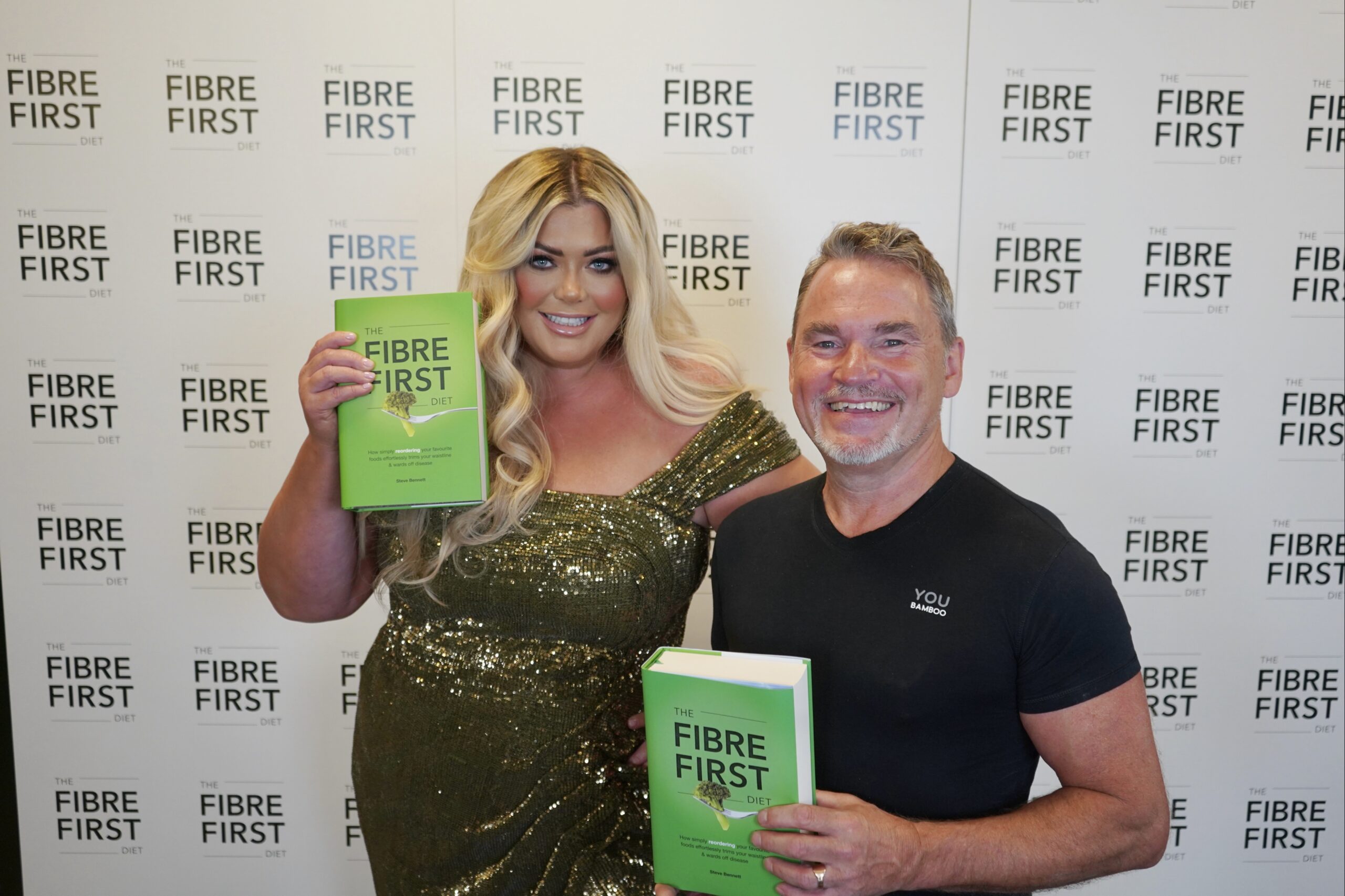 Gemma Collins stands with Steve Bennett, both holding his Fibre First book