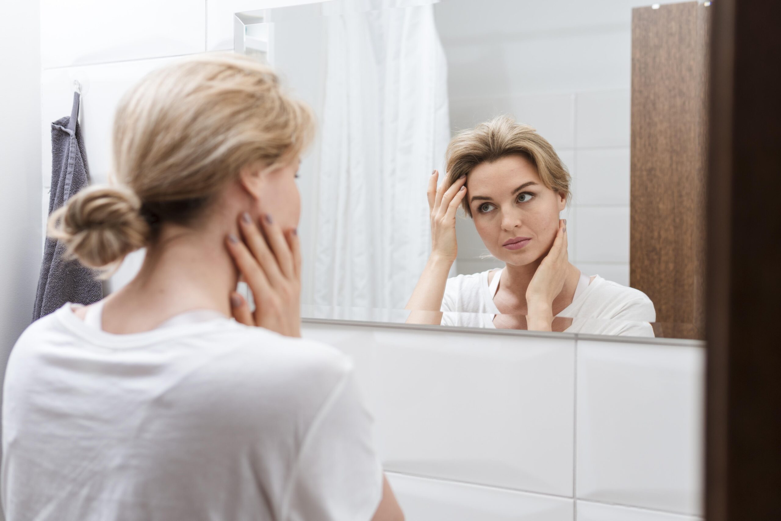 woman-looking-mirror-from-view