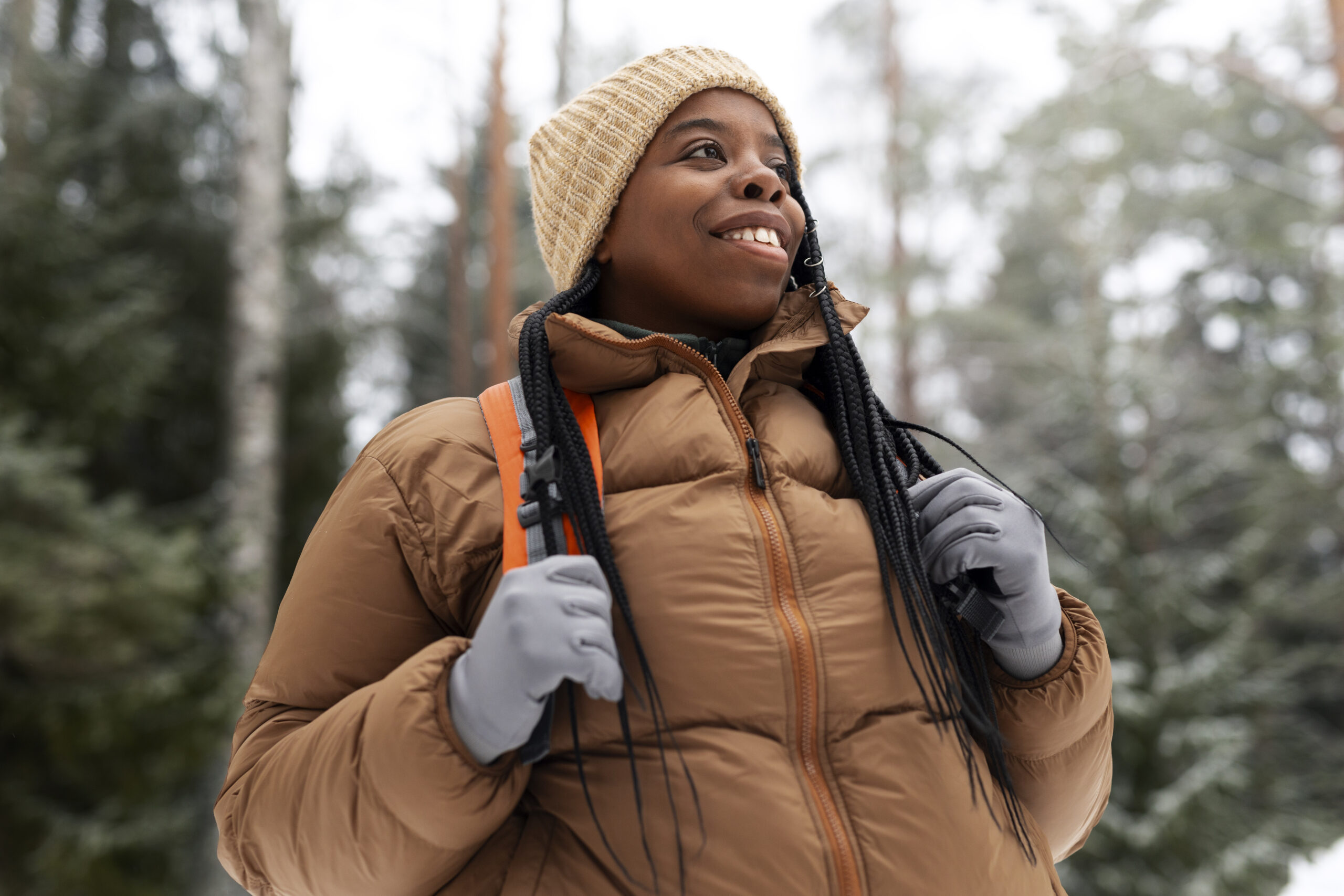 black woman hiking alone and smiling