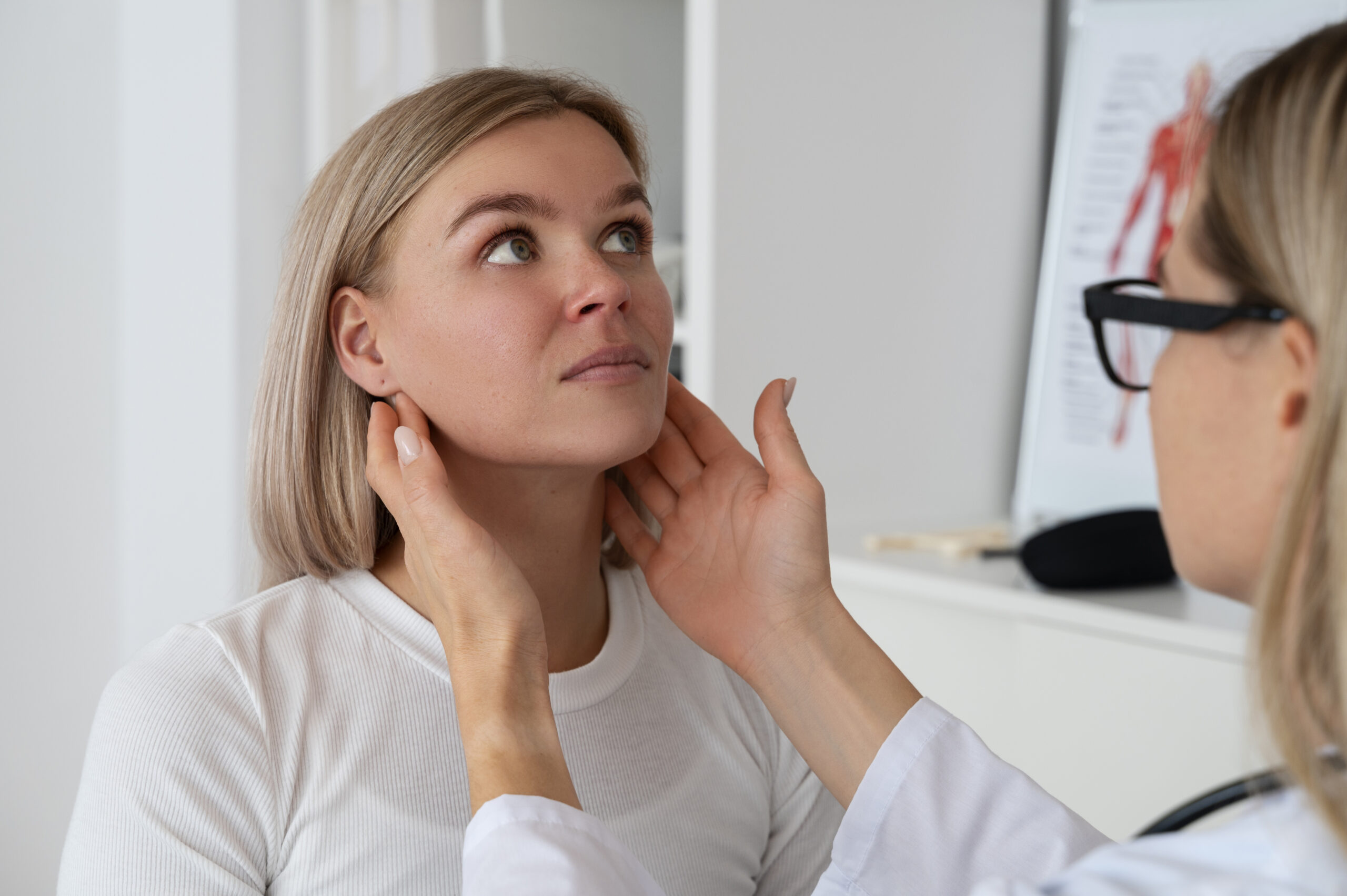 Woman getting her jaw examined by a doctor