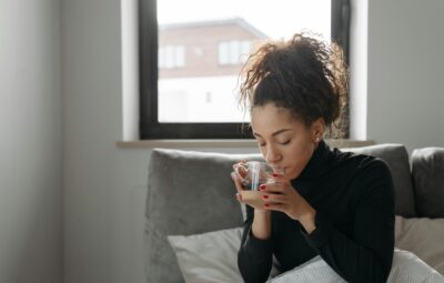 woman in bed sipping a tea with shilajit inside