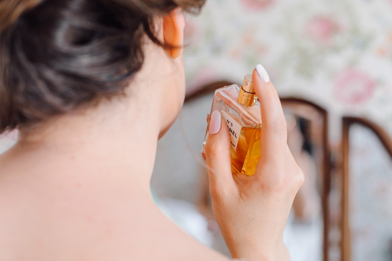 Woman sprays perfume