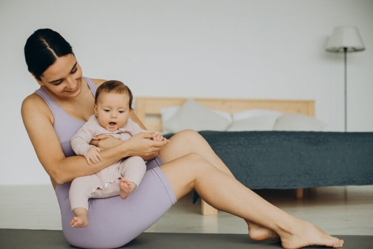 woman sitting on exercise mat to work out with baby