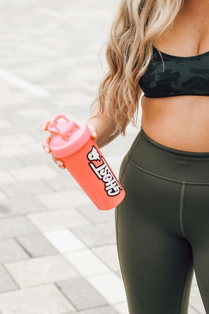 Woman holding a protein bottle