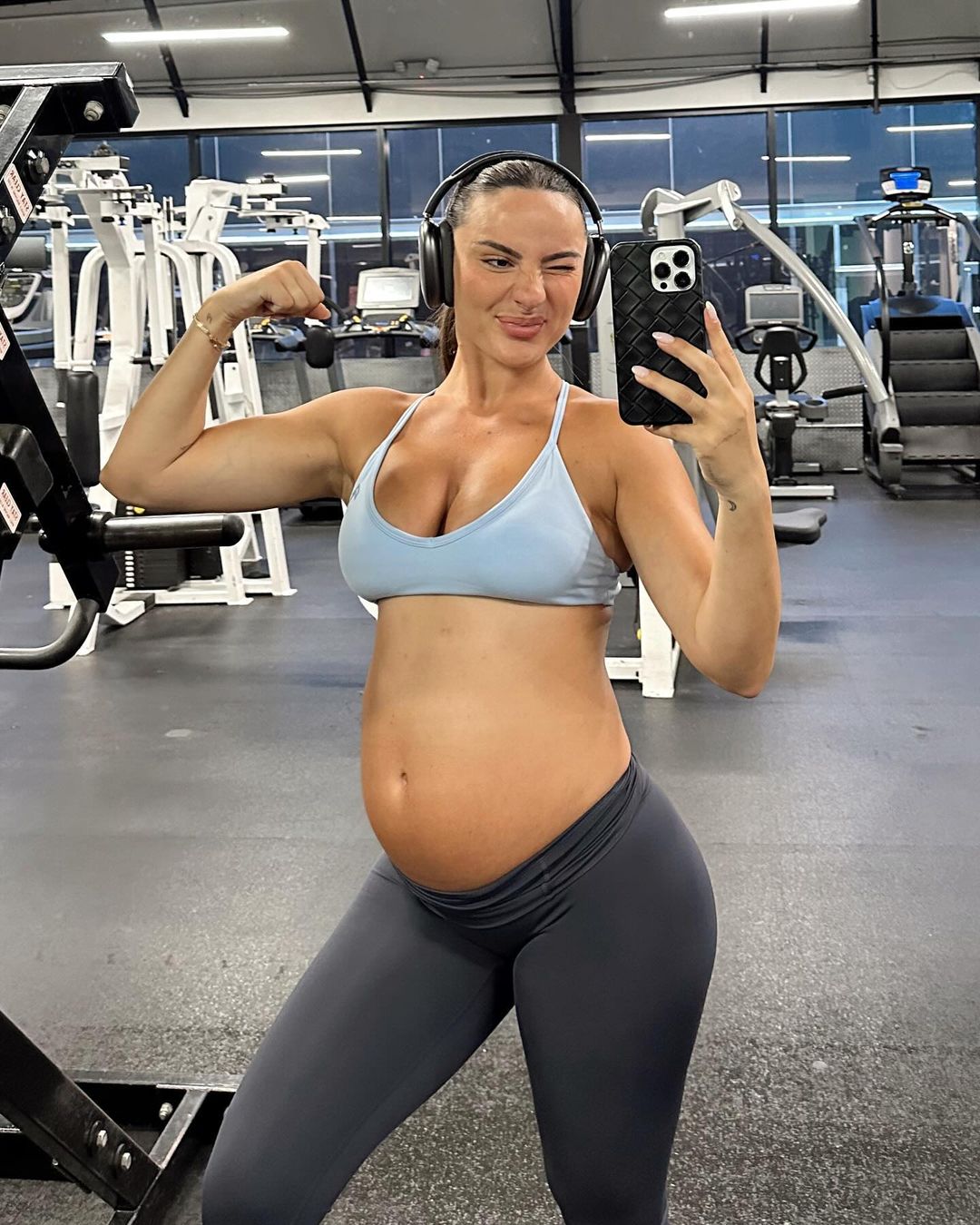 Krissy Cela poses in the gym