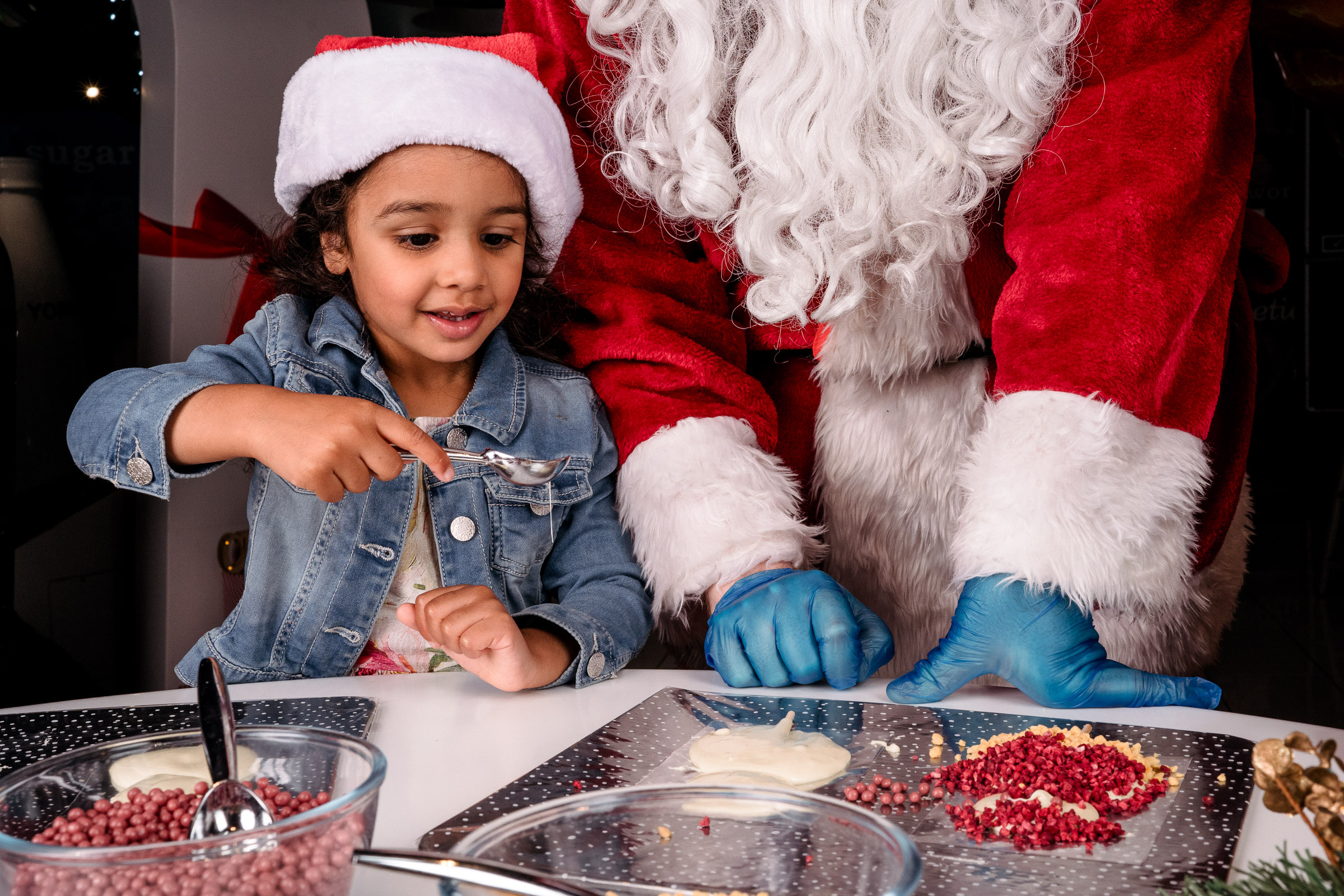 Girl makes chocolate with Father Christmas