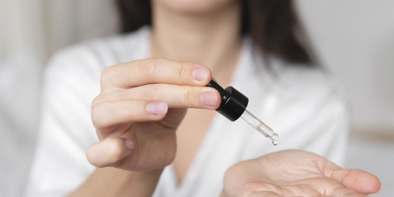 woman drops exosome serum into her hands